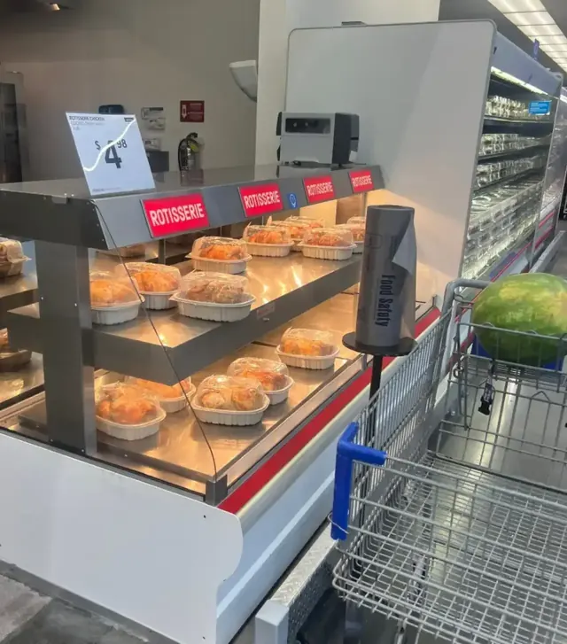 Heated rotisserie display case installed and stocked on a warehouse-store sales floor
